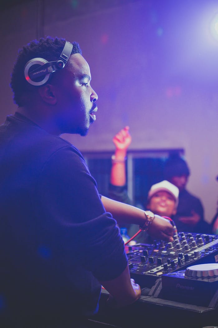 Home Dynamic scene of a DJ mixing music at a lively nightclub party.